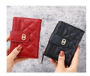 Close-up of quilted PU leather mini wallets in burgundy and black with gold ring buckle