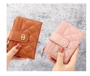 Detail showing quilted leather texture and golden metal buckle on women's short wallet