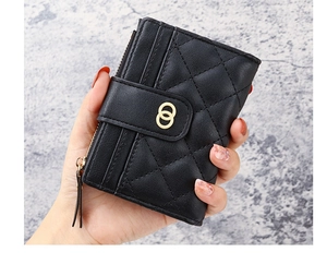 Detail of a black quilted leather women's wallet featuring a gold double-ring clasp