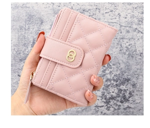 Detail of pink quilted PU leather wallet with card slots and gold ring buckle