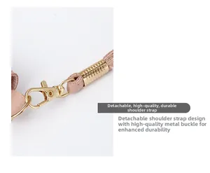 Close-up of detachable pink PU leather strap with polished golden lobster clasp and tassel