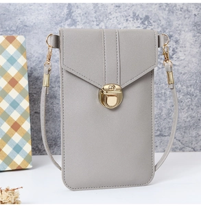 Detail of grey PU leather crossbody phone bag with gold metal buckle and fine texture