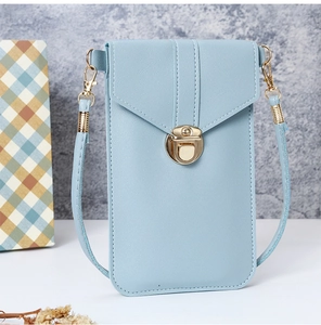 Close-up of light blue PU leather phone bag with elegant gold circular metal clasp detail