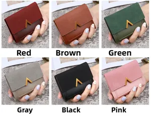 Short tri-fold wallets for women in six colors featuring a gold V-shaped metal buckle detail