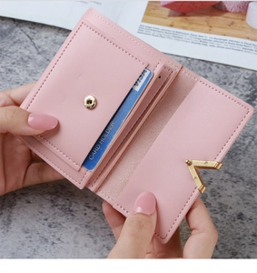 Pink PU leather wallet detail showing card slots and golden V-shaped metal closure