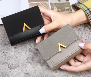 Detail view of tri-fold PU leather wallets with elegant gold V-shape metal buckle