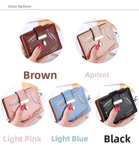 Detailed view of hollow leaf pattern and metal leaf pendant on colorful short wallets