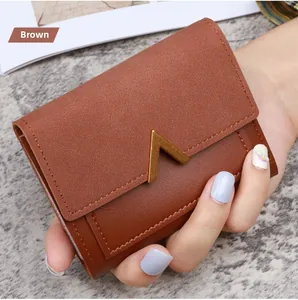 Brown faux leather tri-fold wallet for women with elegant golden V-shaped magnetic buckle