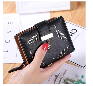 Close-up of black PU leather wallet with hollow gold leaf decor and metal buckle