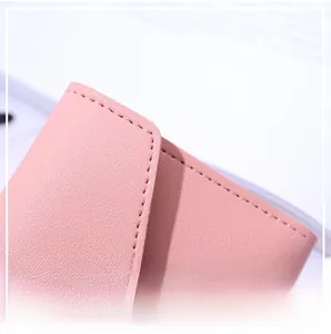 Close-up of pink heart wallet with neat stitching and litchi texture synthetic leather