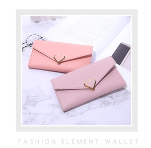 Detail of pink long envelope wallets featuring heart-shaped gold buckles and PU leather