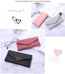 Close-up of long envelope wallets with heart metal buckles in multiple pastel colors