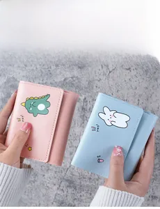 Close-up of cute cartoon dinosaur and rabbit prints on colorful tri-fold PU leather wallets
