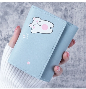 Close-up of light blue wallet featuring a minimalist cartoon polar bear with Hey text