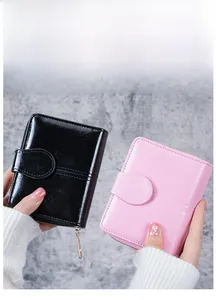 Detailed comparison of pink and black short oil-wax leather wallets with snap closure