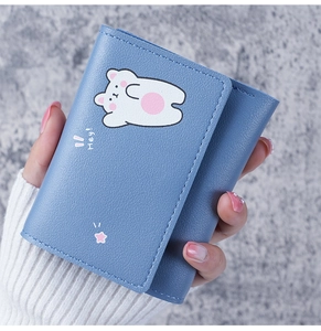 Close-up of blue pebbled PU leather wallet with cute white cartoon bear and Hey text