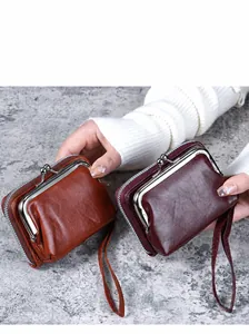 Detail of vintage fashion purses in brown and wine red with metal kiss-lock and side zipper