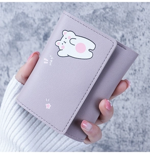 Close-up of lavender faux leather wallet with cute cartoon bear and Hey! lettering