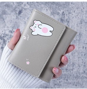 Detail of grey PU leather wallet featuring a cute cartoon bear and premium stitching