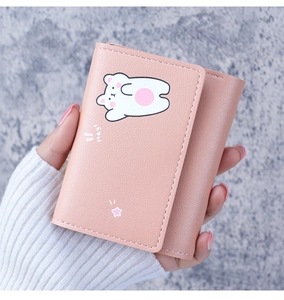 Close-up of pink leather wallet with litchi texture and cute bear motif