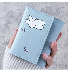 Close-up of light blue trifold wallet with cute rabbit print and textured PU leather