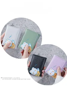 Detail view of mini tri-fold PU leather wallets with cute bear prints in four colors