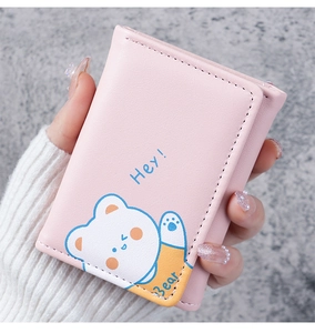 Close-up of pink foldable wallet with cartoon bear pattern and Hey Bear decorative text