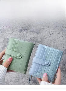 Close-up of mint and blue crocodile texture leather purses with multiple card slots