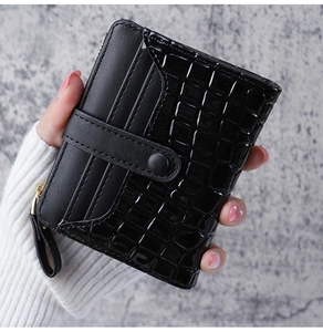 Close-up of black crocodile pattern wallet with card slots and snap button closure