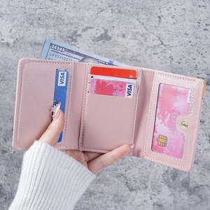 Pink trifold wallet for women featuring multiple card slots and a clear ID window