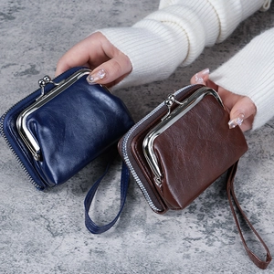 Retro faux leather clasp purse with zipper in navy and brown, features pebble texture.