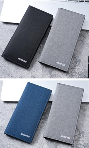 Three long slim wallets in black, grey, and blue displayed in an office setting