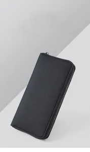 Detailed close-up of men's long canvas wallet with cross-pattern texture and silver zipper