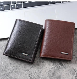 Close-up of litchi grain PU leather men's wallets in black and brown with metal logo