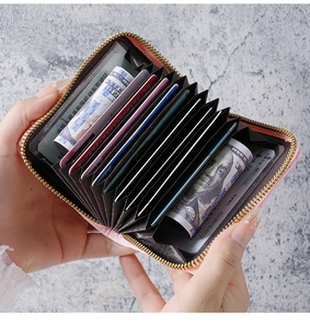Pink textured leather accordion card wallet with gold zipper and multi-slot interior