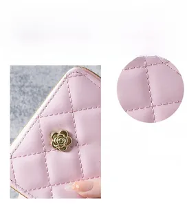Detail of pink lavender quilted leather wallet featuring golden flower metal accessory