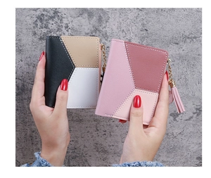 Detailed view of color-block PU leather wallets with tassels and metallic zippers