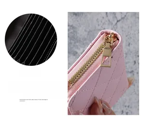 Detail of pink quilted accordion card holder with golden metal zipper and PU leather texture