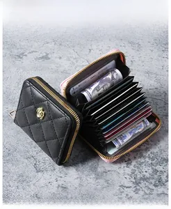 Detail of quilted leather card holders with gold camellia accent and accordion card slots