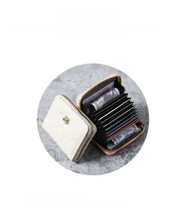 Detail view of the quilted accordion card wallet with golden flower buckle and multi-slots