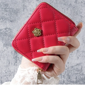 Detail of red quilted faux leather wristlet wallet with gold flower hardware