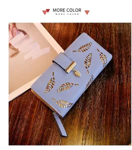Detailed laser-cut leaf pattern on light blue PU leather wallet with metallic pendant