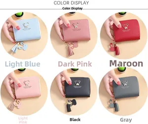 Detail view of mini short wallets in six colors with bear logo and tassel charms