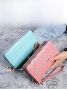 Detail of light blue and pink quilted long wallets with double zippers and wristlet