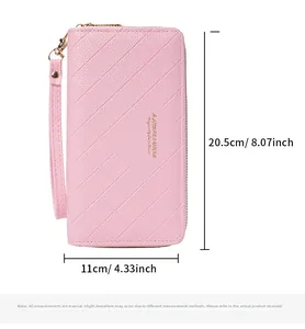 Detail of pink quilted wallet featuring dual gold zippers and a matching wrist strap