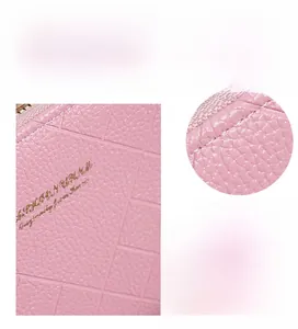 Close-up of pink embossed leather wallet showing neat stitching and grid texture detail