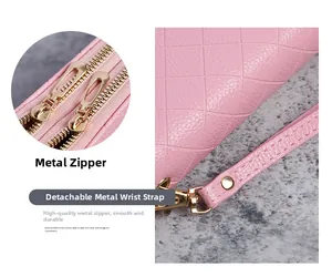 Detail of pink long wallet showing dual gold zippers and rhombus quilted texture