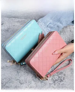 Detail of blue and pink quilted long wallets with double zippers and wrist straps