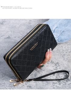 Detail of black double-zipper long wallet with quilted pattern and gold hardware strap
