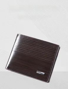 Detail of dark brown leather wallet showing fine horizontal stitching and wood grain texture
